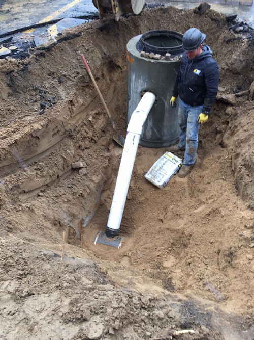 DE Construction worker installing a Storm Sewer at Flagstar Bank in Jackson Michigan